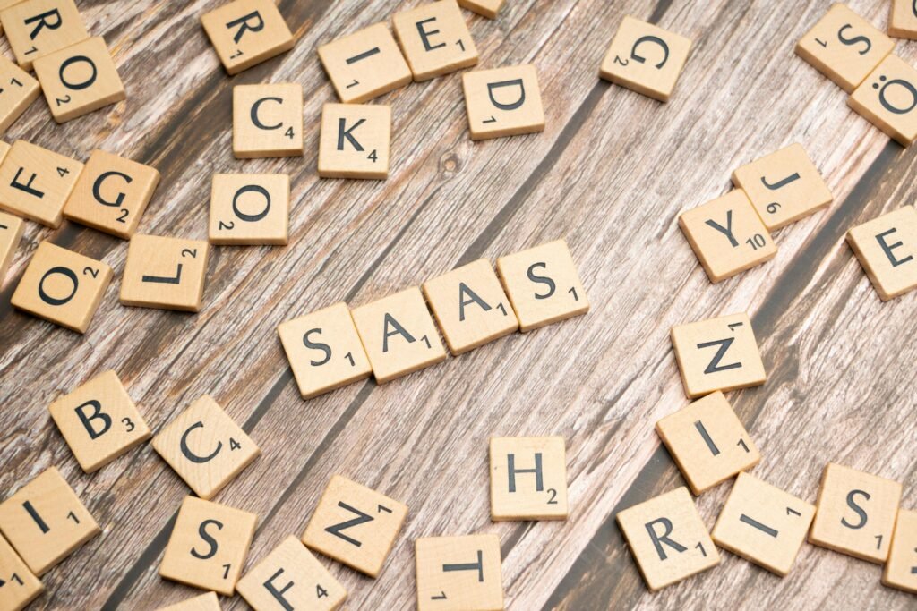 pexels-photo-19867468-19867468 Wooden letter tiles spelling SaaS on rustic wood. Ideal for cloud computing and business concepts.